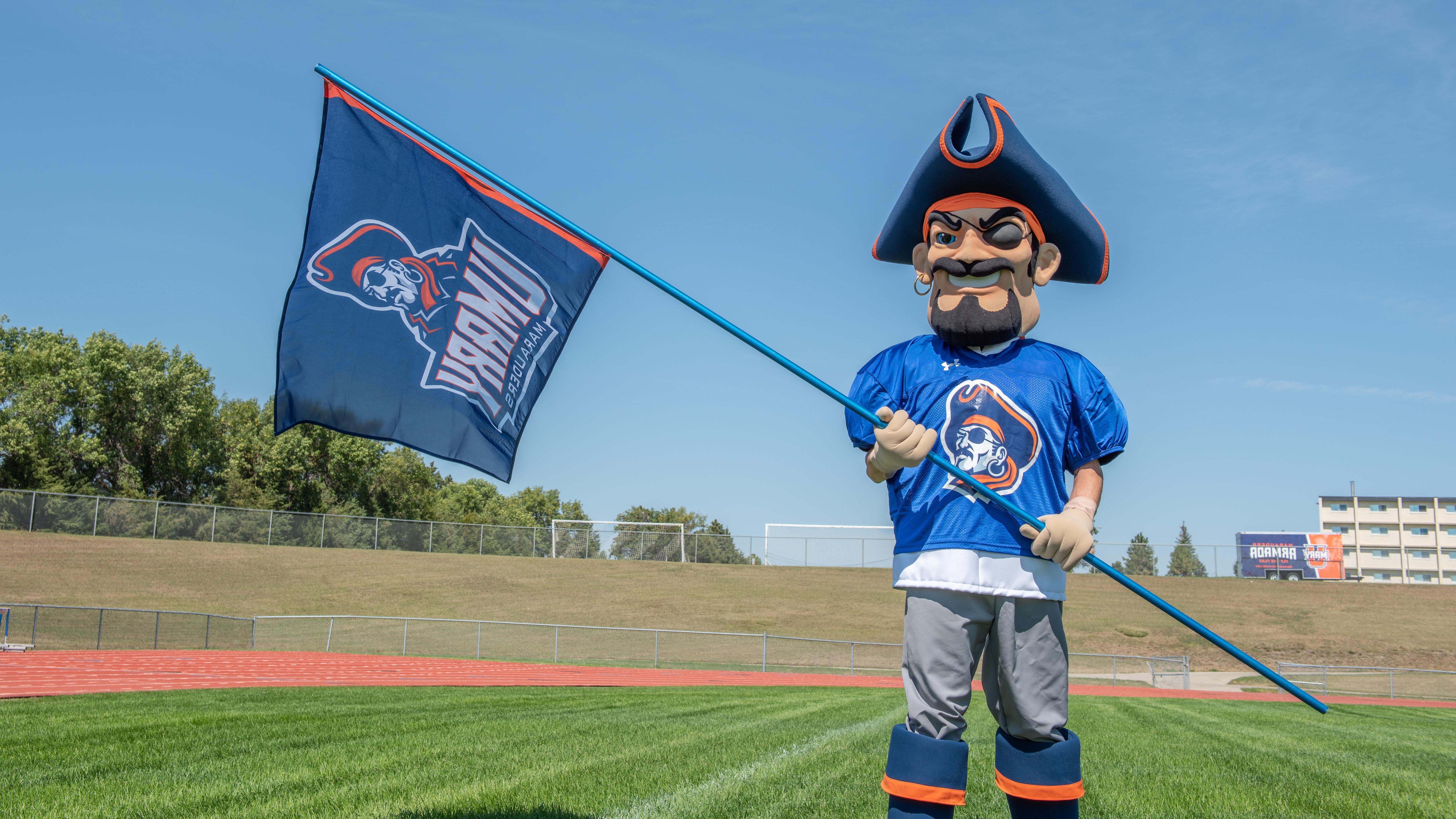 Max the Marauder holding the UMary athletics flag